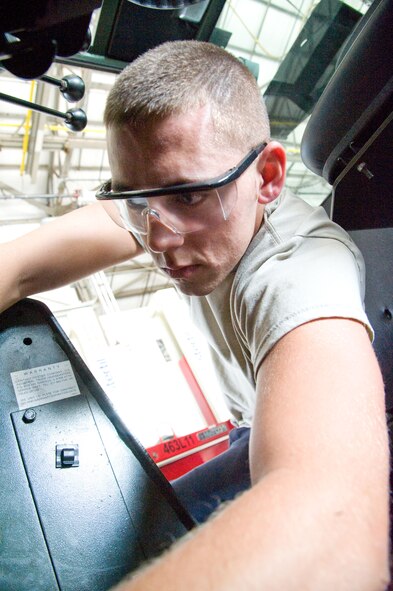 Airman Jeremy Divine, materials handling and equipment specialist with the 436th Logistic Readiness Squadron, replaces cotter pins in a forklift July 18, 2012, at Dover Air Force Base, Del. The 436th LRS repairs various vehicles required for cargo transport at Dover AFB. (U.S. Air Force photo by Adrian R. Rowan)