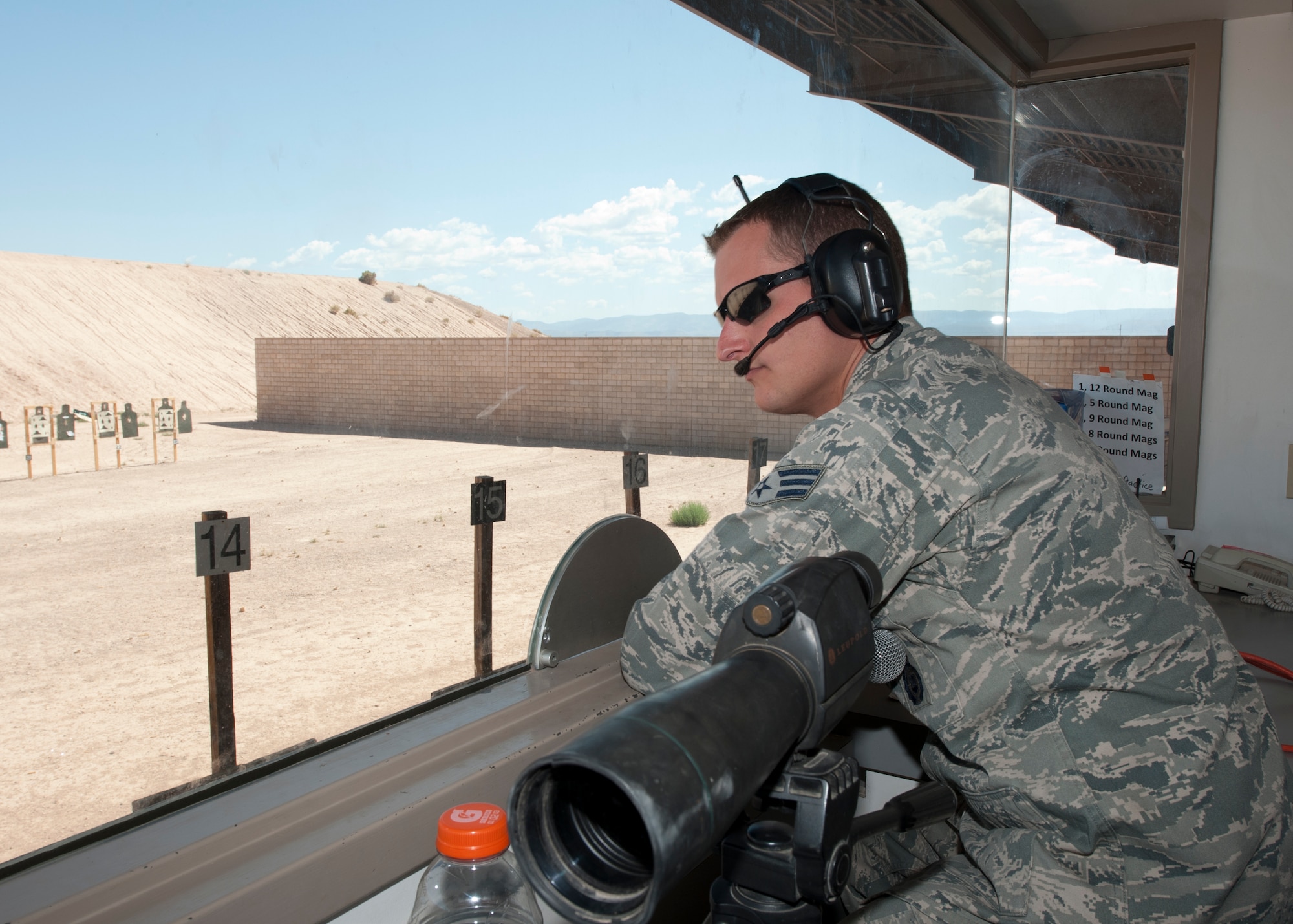 Senior Airman James Seaborn, 49th Security Forces Squadron Combat Arms Training and Maintenance instructor, watches the firing line at the Holloman Air Force Base, N.M., Combat Arms Training and Maintenance range July 18. Seaborn is one of the many CATM instructors that ensure the safety of every Airman on the firing line. As the front-line facilitators for the course, the CATM instructors teach a weapons-familiarization training block taught in the classroom and at the shooting range. (U.S. Air Force photo by Airman Leah Ferrante/Released)