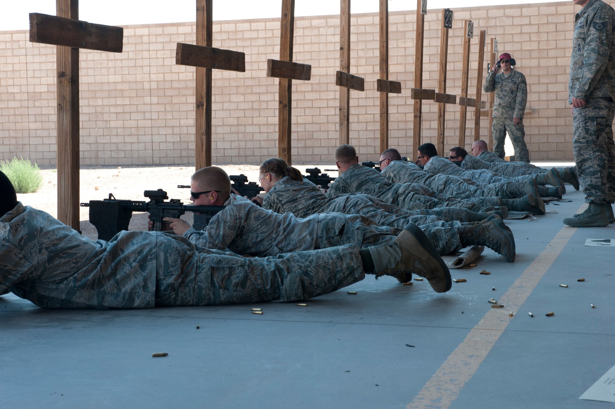 Airmen shoot the M-4 rifle during weapons qualifications at the Holloman Air Force Base, N.M., Combat Arms Training and Maintenance range July 18. Before any Holloman Airman goes on a deployment, they must complete the weapons qualifications course, which includes a weapons-familiarization training block taught in the classroom and at the shooting range. To qualify, Airmen must shoot targets at 7, 15 and 25 meters, while going through a combination of multiple target drills, threat discrimination, and burst-fire sessions. (U.S. Air Force photo by Airman Leah Ferrante/Released)
