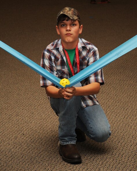 Jackson Klever, Louisiana Gaining Early Awareness and Readiness for Undergraduate Program student, uses a rubber band to slingshot a ball to his classmates during a leadership activity at Hoban Hall on Barksdale Air Force Base, La., July 17. The activity was designed to show campers the importance of leadership and allow them to demonstrate those skills. LA GEAR UP is designed to give high school students, who show an interest in aviation, an opportunity to explore the different options available to them after graduation. (U.S. Air Force photo/Senior Airman Sean Martin)(RELEASED)