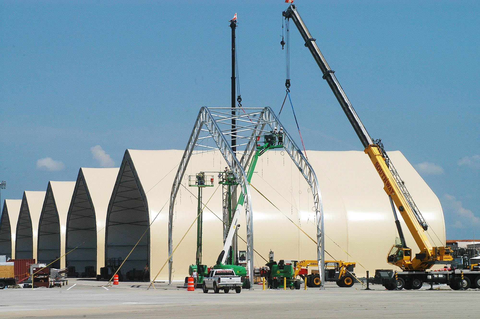Construction workers raise steel trusses Monday on the last C-130 shelter.  (U. S. Air Force photo/Sue Sapp)
