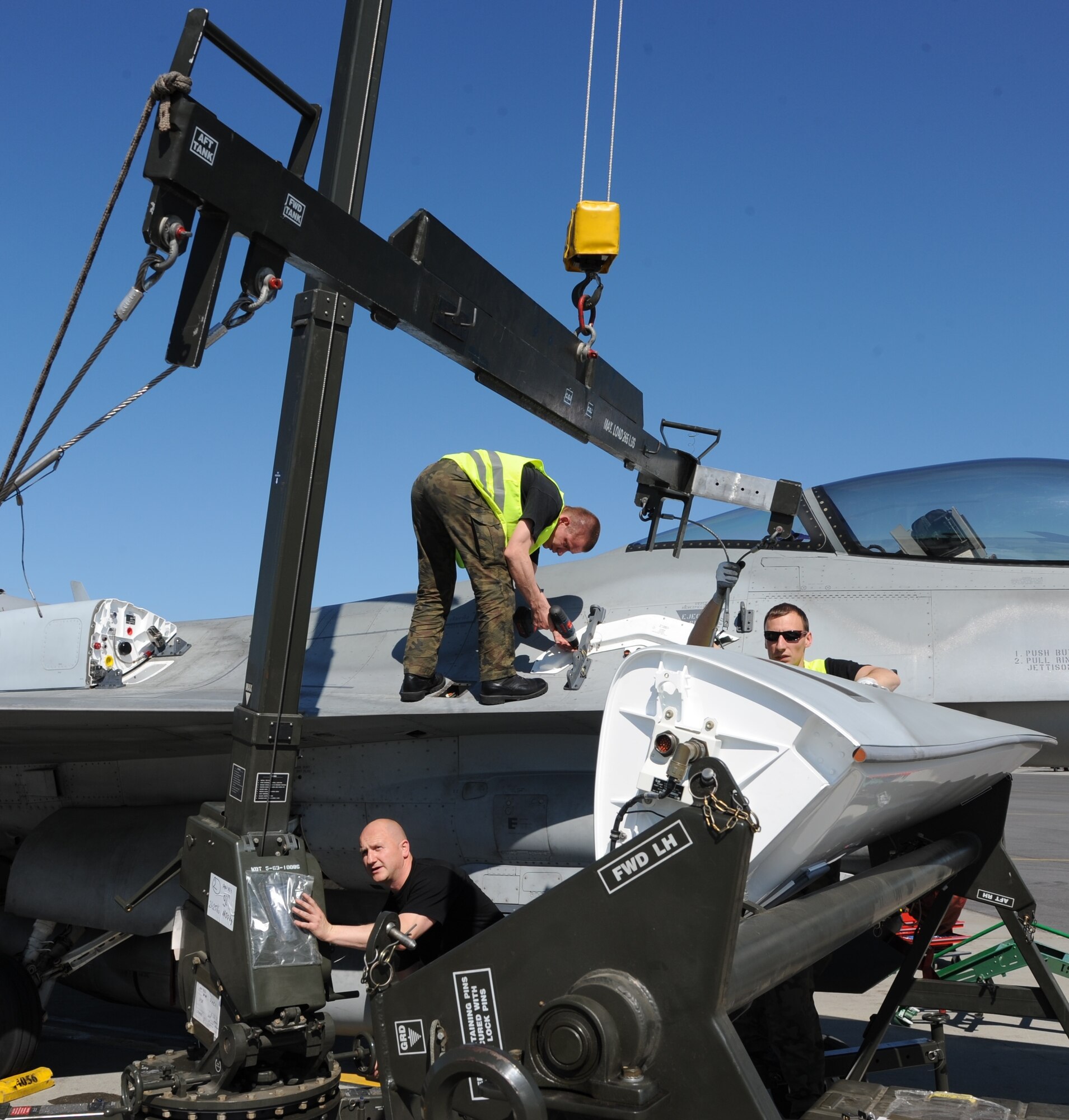 Several Polish Air Force members conduct separate maintenance operations June 21, 2012, Eielson Air Force Base, Alaska. The maintainers are able to conduct many routine maintenance tasks at the same time enabling a more efficient use of time and a quicker aircraft turn-around. The Polish Air Force was a participant in Red Flag-ALASKA 12-2, a training exercise enabling air forces to hone tactics ranging from individual skills to complex, large-scale joint engagements. (U.S. Air Force photo by Senior Airman Willard E. Grande II)