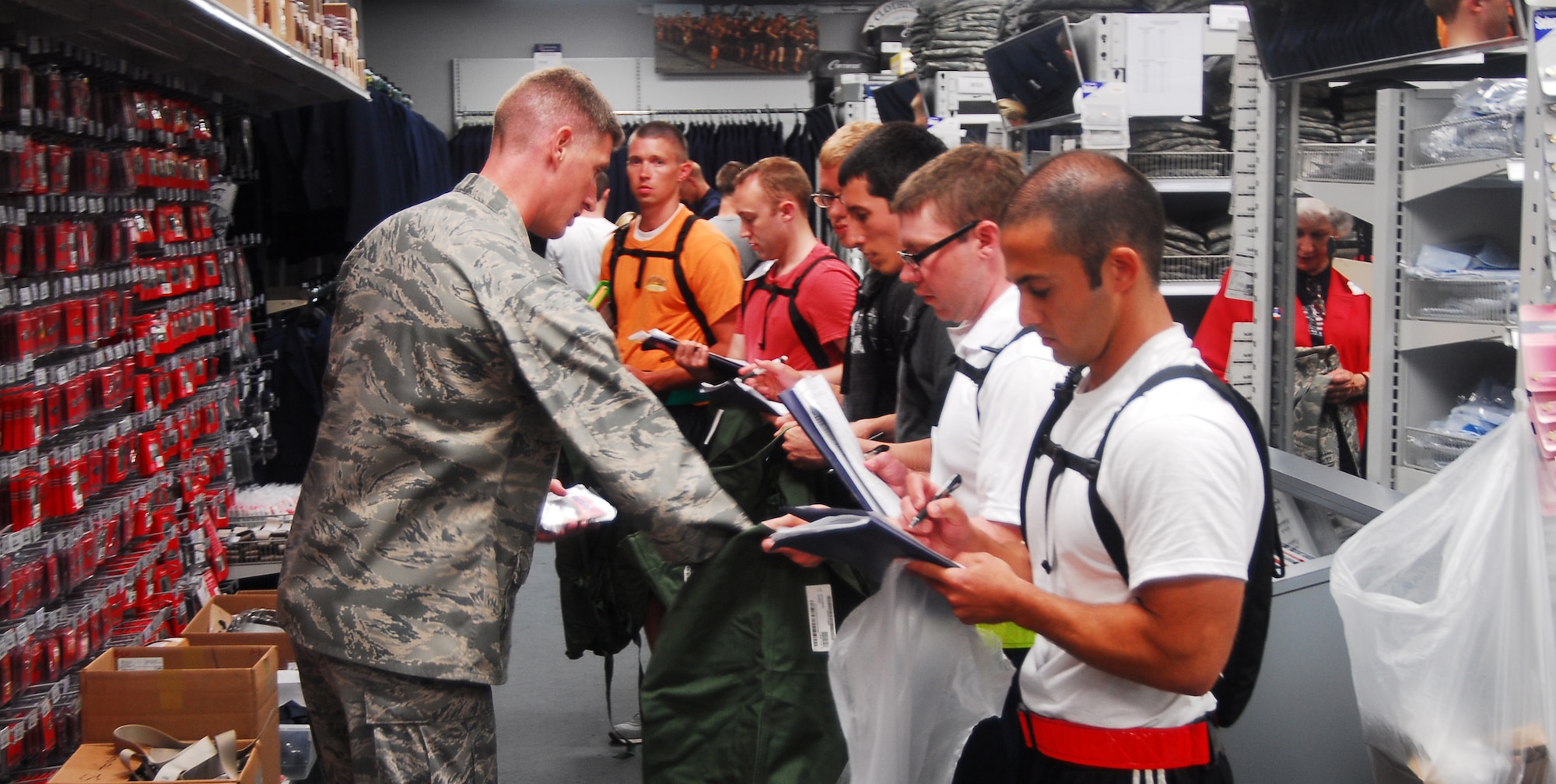 Trainees fill their bags July 3 with things they will need for their 13 weeks at Maxwell. Trainees get all of their clothing and necessary items together as a flight on their second day of their time, here. (U.S. Air Force photo by Airman 1st Class William Blankenship) 
