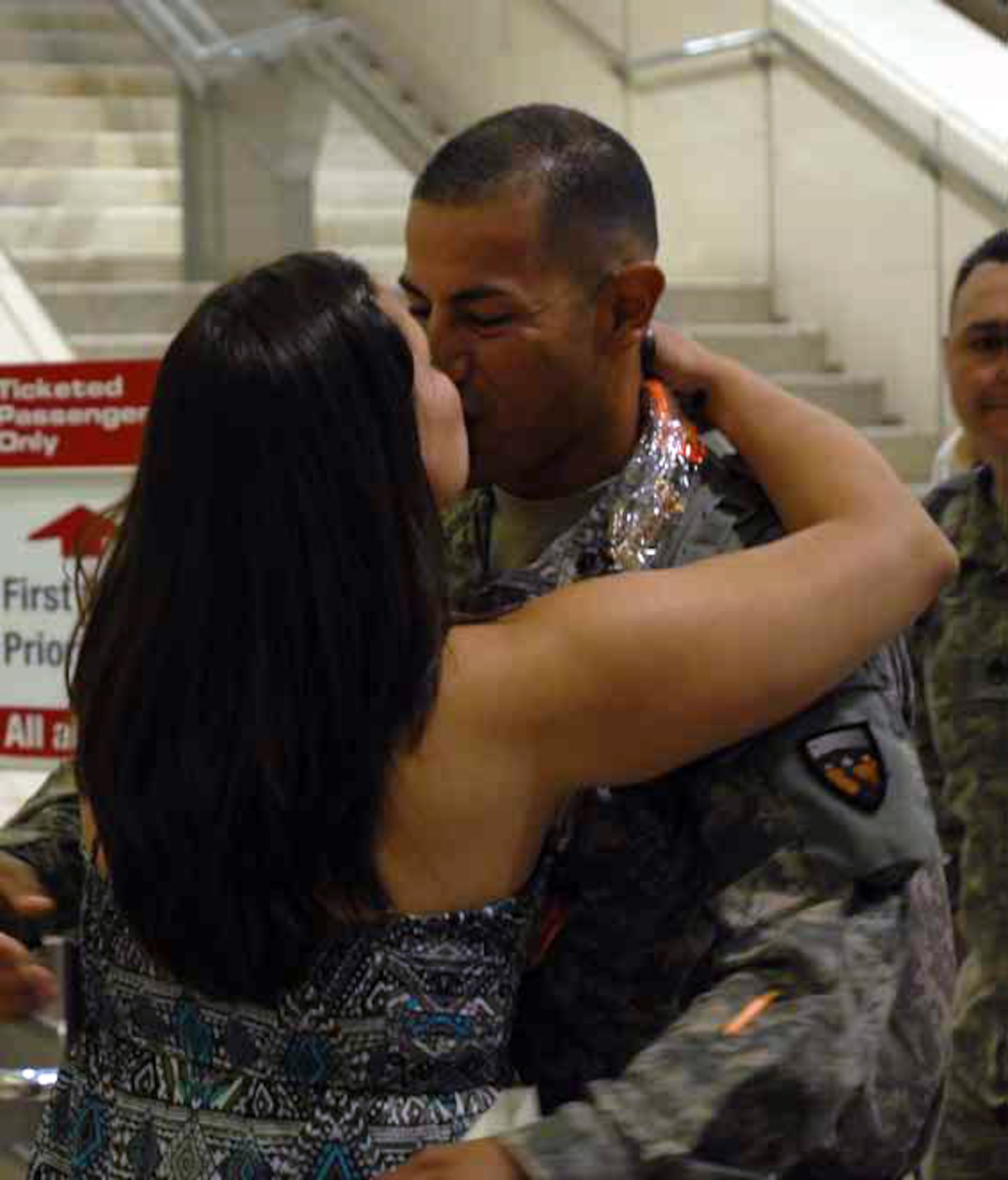 Staff Sgt. Nelson Villacorta embraces his wife Brandy at Ontario International Airport. (U.S. Army photos by Sgt. Tracy Ellingsen)