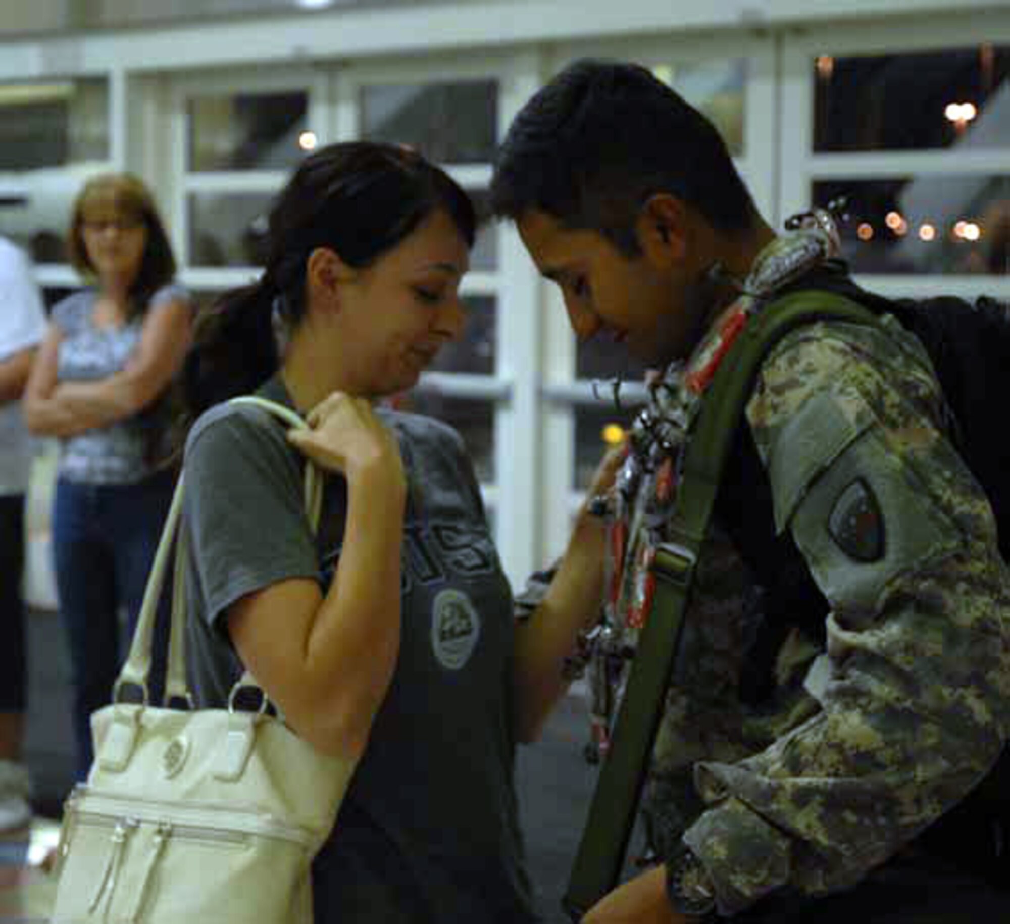 Spc. Vardon Reyes and his girlfriend Angelina Serna share a moment while waiting for Reyes’ luggage at Ontario International Airport. (U.S. Army photos by Sgt. Tracy Ellingsen)