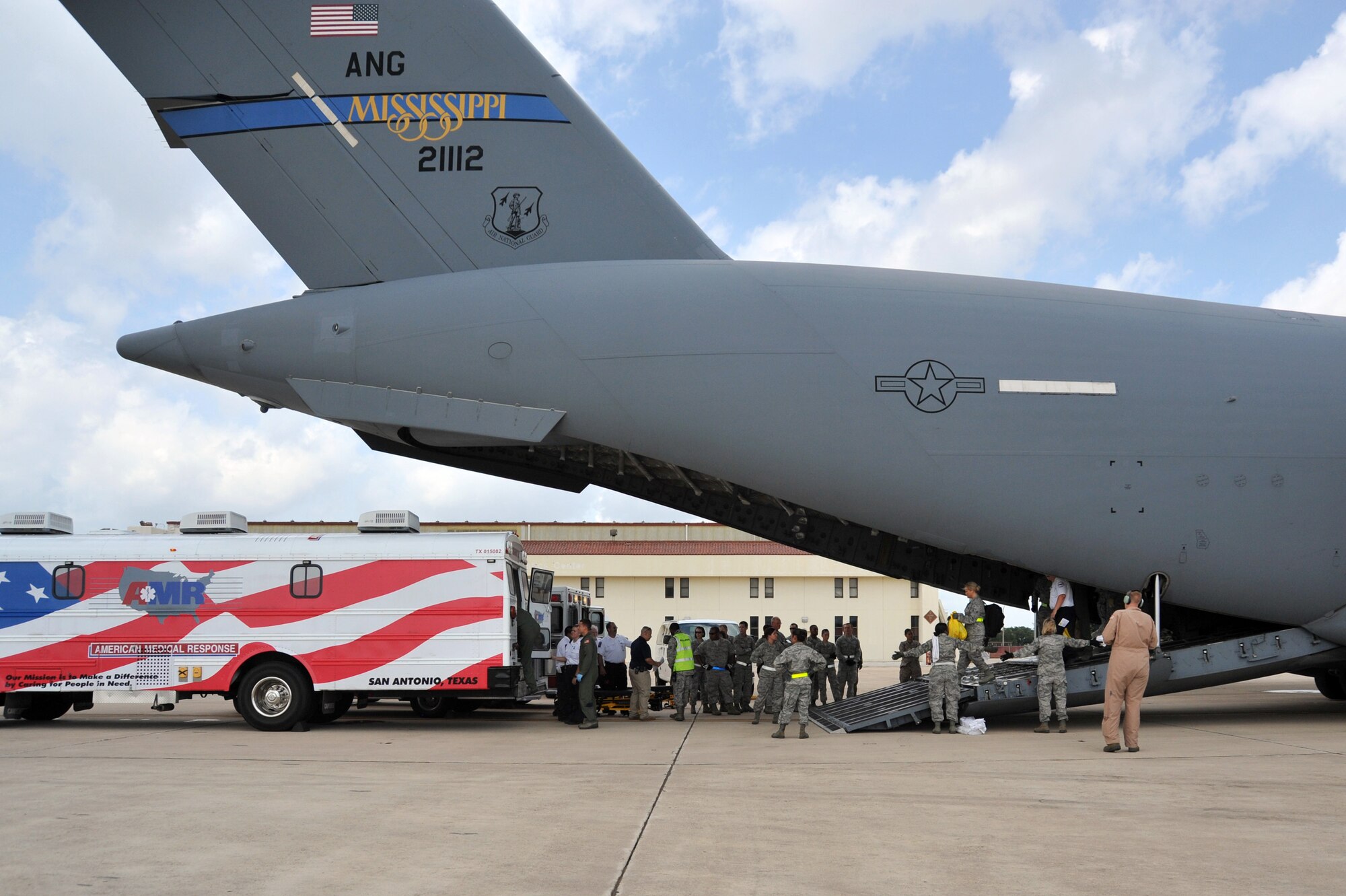 Service members of the 59th Contingency Aeromedical Staging Facility and Air Force personnel assist wounded warriors off a C-17 Globemaster III that arrived on Joint Base San Antonio-Lackland flightline on July 10, 2012. (U.S. Air Force photo/Desiree N. Palacios)