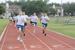Joint Base San Antonio-Randolph personnel prepare for their physical training test during an early morning run July 13 on the Rambler Fitness Center track at Randolph. (U.S. Air Force photo by Rich McFadden)