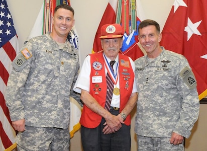 FORT SAM HOUSTON, Texas — Darrell G. Harris, a veteran paratrooper of 3rd Battalion, 504th Parachute Infantry Regiment, 82nd Airborne Division, from World War II, is flanked by Maj. Roger Wang and Lt. Gen. William Caldwell IV after being presented a Lifetime Achievement Award for his actions and service during WWII at a ceremony July 13 at the U.S. Army North Headquarters. Caldwell is the commanding general of U.S. Army North and senior commander for Fort Sam Houston and Camp Bullis, and Wang serves with the 504th Para. Inf. Regt., 82nd Abn. Div. (U.S. Army photo by Sgt. 1st Class Christopher DeHart, Army North PAO)