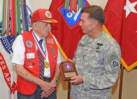 FORT SAM HOUSTON, Texas — Lt. Gen. William Caldwell IV presents a Lifetime Achievement Award to Darrell G. Harris on behalf of the 82nd Airborne Division Association for his actions and service during WWII July 13 at the U.S. Army North Headquarters in the Quadrangle here. Harris is a veteran paratrooper of 3rd Battalion, 504th Parachute Infantry Regiment, 82nd Airborne Division, from World War II. Caldwell is the commanding general of U.S. Army North and senior commander of Fort Sam Houston and Camp Bullis. (U.S. Army photo by Sgt. 1st Class Christopher DeHart, Army North PAO)