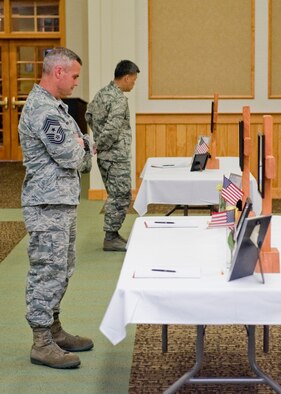 Anderson, left, and Col. H.B. Brual, 341st Missile Wing commander, browse memorials for several security forces Airmen during a ceremony in honor of Memorial Day.  His assignment here at Malmstrom marked his second time serving as a command chief for a wing.  (U.S. Air Force photo/Beau Wade)