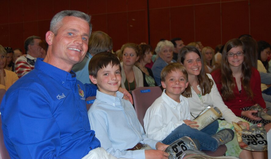 Chief Master Sgt. Charles Anderson, 341st Missile Wing command chief, is shown with four of his six children before the start of the 2011 Tops In Blue performance. Pictured with him from left to right are Chip, 12; Pete, then 8; Gabsy, then 15; and Carissa, then 14. Not shown are son Scott, 6; and daughter Kate, 3. (U.S. Air Force photo/Valerie Mullett)