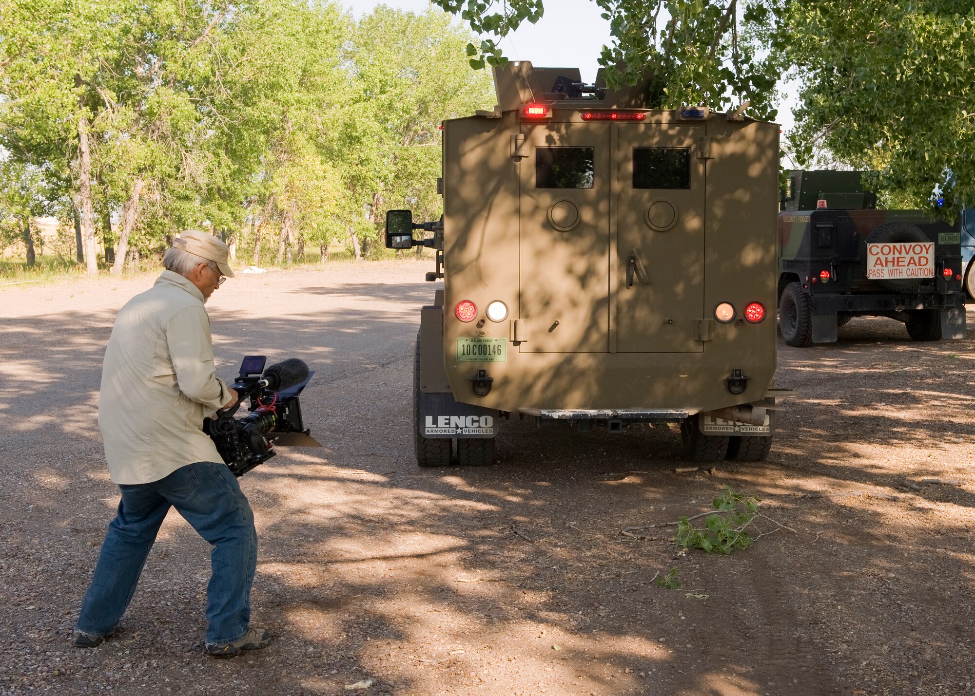 Albert Tinsley, of Cubic Video, films the back of a Bearcat during a training scenario at the Warrior Launch Facility on July 12. The shoot/don’t shoot training exercise video will operate on the Engagement Skill Trainer 2,000 and will serve as a training video for security forces members to hone marksmanship, threat response and combat skills in a variety of environments. (U.S. Air Force photo/Beau Wade)