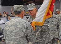 FORT SAM HOUSTON, Texas — Lt. Gen. William Caldwell IV passes the battalion colors to Lt. Col. Zoltan Krompecher as the Soldiers and civilians of Headquarters and Headquarters Battalion, U.S. Army North, witnessed the battalion’s inaugural change of command and change of responsibility ceremony at Fort Sam Houston’s Rehearsal of Concept Drill Facility July 12. Caldwell, the commanding general of U.S. Army North and senior commander of Fort Sam Houston and Camp Bullis, served as the reviewing officer for the ceremony. Krompecher assumed command from Lt. Col. Shannon Miller, and Command Sgt. Maj. Alvin Chaplin Sr. assumed responsibility for the battalion from Command Sgt. Maj. Eddie Fields III. (U.S. Army photo by Staff Sgt. Corey Baltos, Army North PAO)