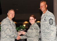 Col. Scott Rizer 319th Air Base Wing vice commander, presents Airman 1st Class Vivienne Cassidy, Logistics Readiness Squadron, with a Diamond Sharp Award July 19, 2012, on Grand Forks Air Force Base, N.D., accompanied by 319th ABW Command Chief Master Sgt. David Carlson.  The Diamond Sharp Award is given to Airmen who epitomize service before self and strive for excellence at work and off duty.  (U.S. Air Force photo by Airman 1st Class Xavier Navarro)  