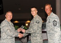 Col. Scott Rizer 319th Air Base Wing vice commander, presents Senior Airman Ryan Laube, Communications Squadron, with a Diamond Sharp Award July 19, 2012, on Grand Forks Air Force Base, N.D., accompanied by 319th ABW Command Chief Master Sgt. David Carlson.  The Diamond Sharp Award is given to Airmen who epitomize service before self and strive for excellence at work and off duty.  (U.S. Air Force photo by Airman 1st Class Xavier Navarro)  
