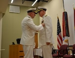Vice Adm. Matthew Nathan, surgeon general of the Navy and chief, Bureau of Medicine and Surgery, awards the Legion of Merit to Rear Adm. Bob Kiser during his retirement ceremony June 15. Kiser, the first commandant of the Medical Education and Training Campus, retired after 38 years of combined reserve and active duty service. (U.S. Navy photo by Lisa Braun/Released