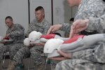 Soldiers from units on Fort Bliss participate in Basic Life Support recertification training including how to respond to unresponsive infants who are choking " at the Medical Simulation Training Center on Fort Bliss. (U.S. Army photo by Jennifer Clampet)