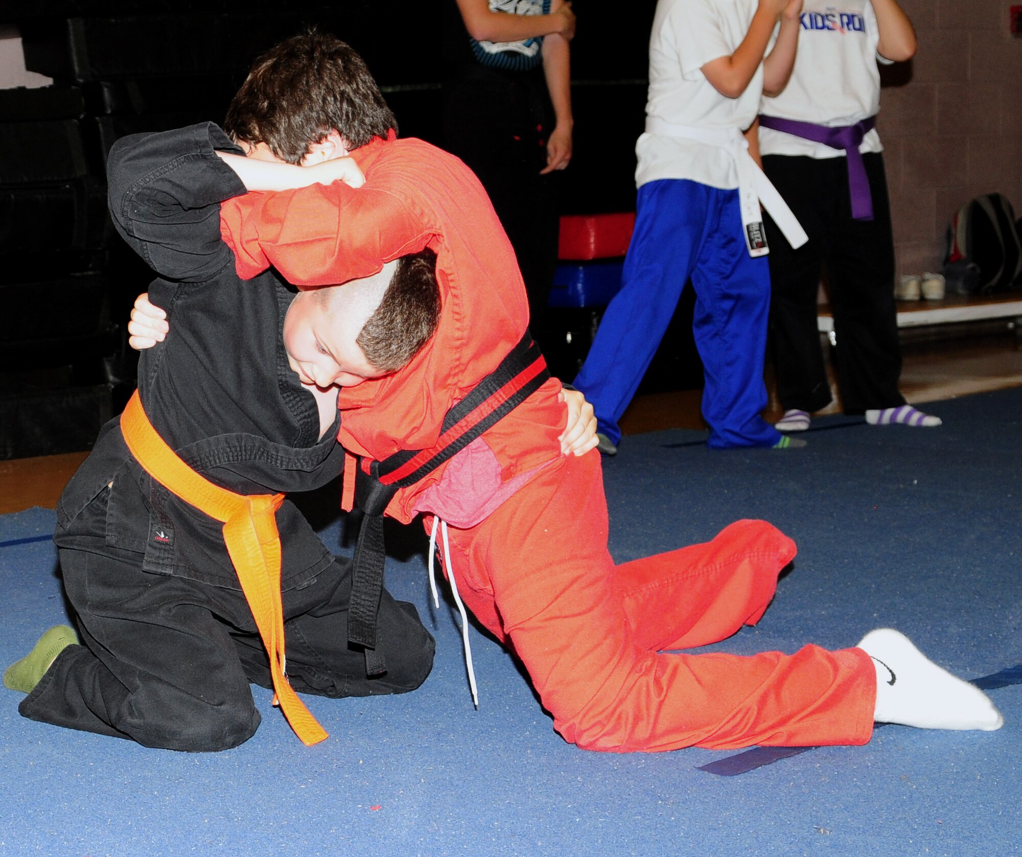 RAF MILDENHALL, England – Matthew Jalufka, 11, and Ethan Newman, 7, practice Hapkido basic floor sparring moves during a karate camp July 17, 2012, at the RAF Mildenhall Youth Center. The karate camp is just one of many activities to keep children entertained throughout the summer. For more information on other youth center camps and activities, call DSN 238-2831. (U.S. Air Force photo/Karen Abeyasekere)