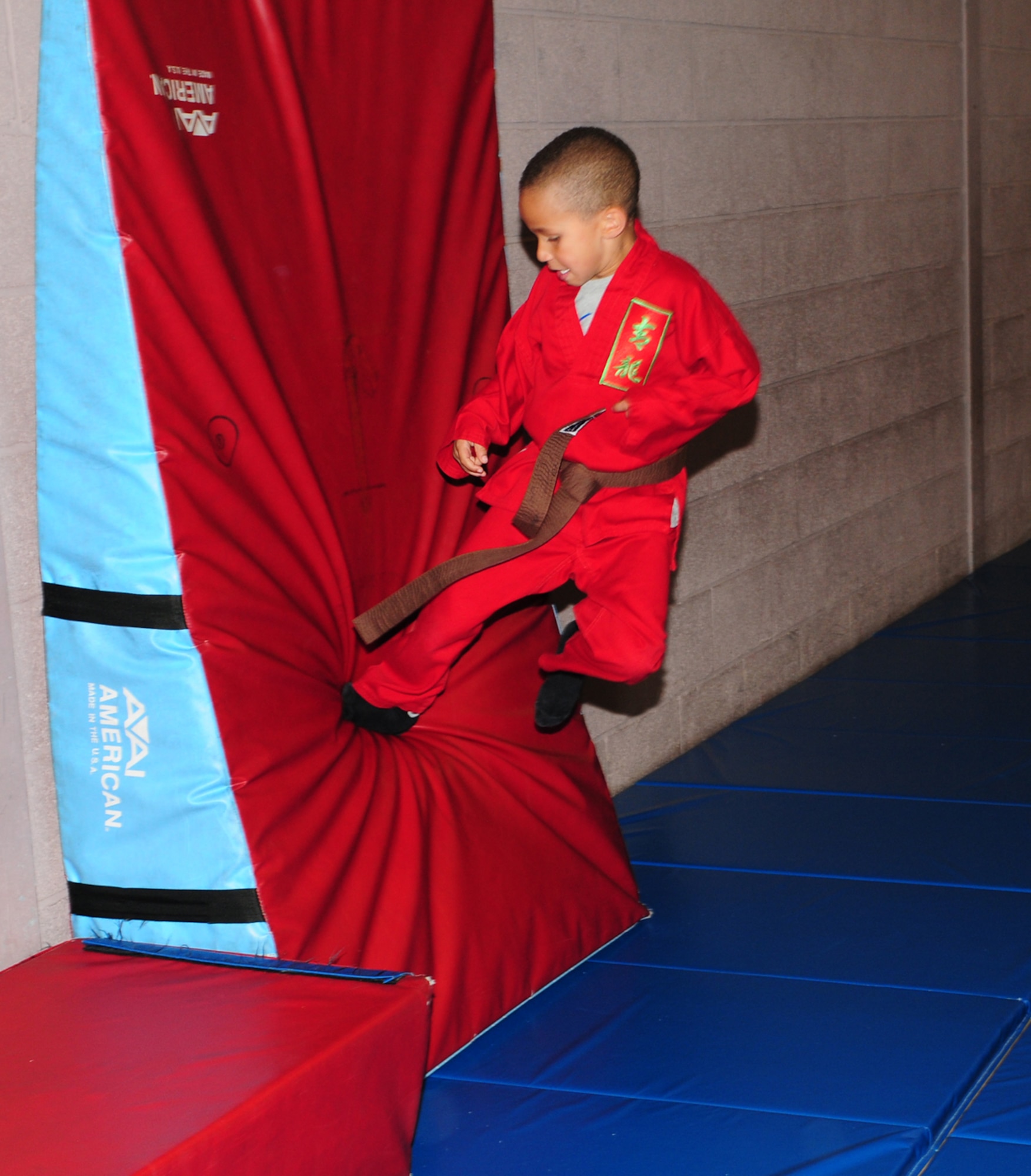 RAF MILDENHALL, England – Tyler Thompson, 7, practices flying side-kicks during a karate camp at the RAF Mildenhall Youth Center July 17, 2012. Taught by Green Turner, 100th Force Support Squadron and a Green Dragon Martial Arts instructor, the karate camps are held throughout the summer vacation and aim to teach children a combination of Hapkido and Tae Kwon Do. The karate camp is held once a month, and the next one is scheduled for Aug. 20 to 22. For more information or to sign up, call the youth center at DSN 238-2831. (U.S. Air Force photo/Karen Abeyasekere)
