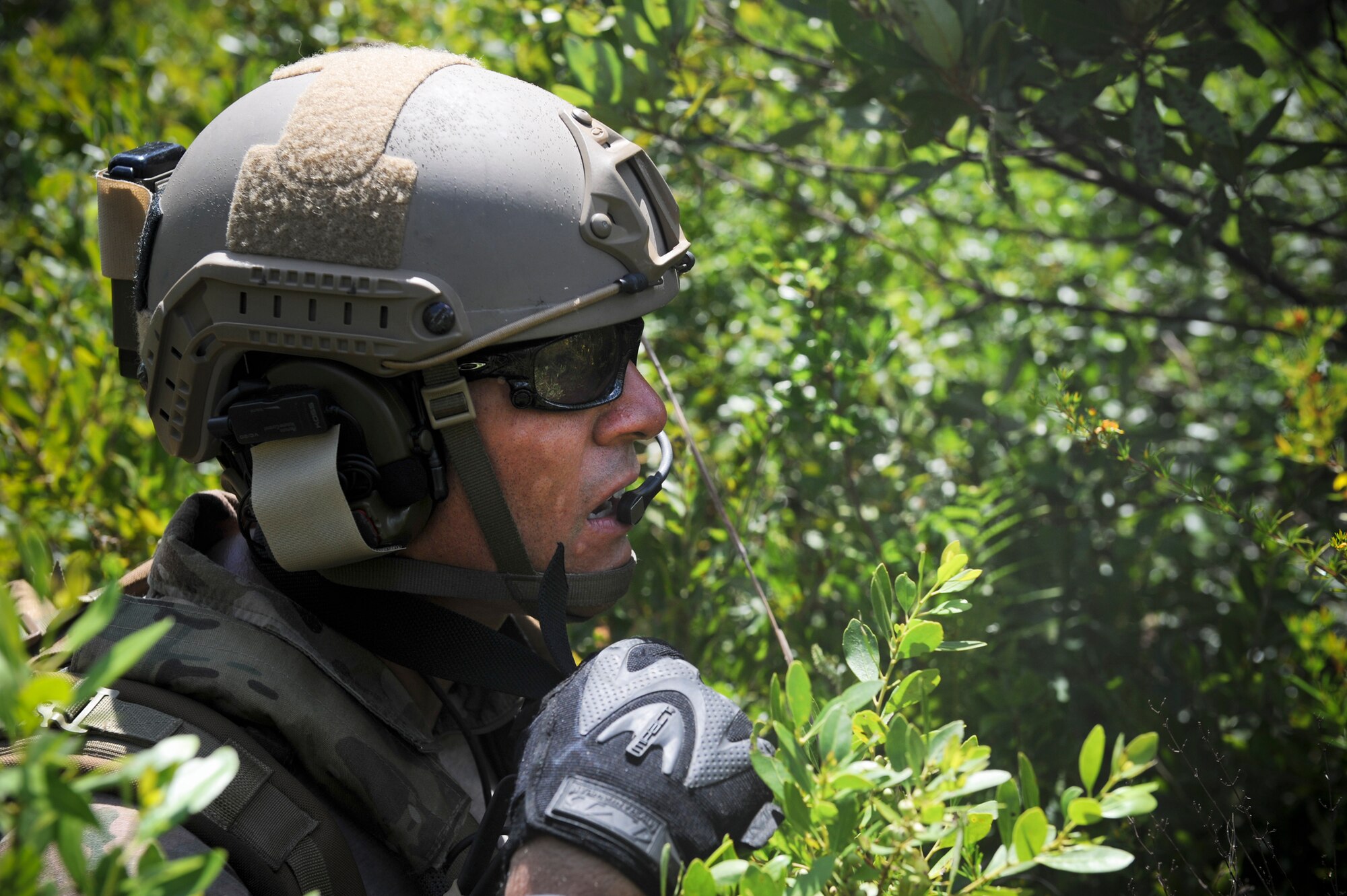 U.S. Air Force 1st Lt. Andrew Hendel, 38th Rescue Squadron combat rescue officer, uses a radio to maintain contact with an injured person during a training scenario at Moody Air Force Base, Ga., July 16, 2012. During their discussion, Hendel obtained the person’s GPS coordinates before moving toward his location. (U.S. Air Force photo by Airman 1st Class Douglas Ellis/Released)
