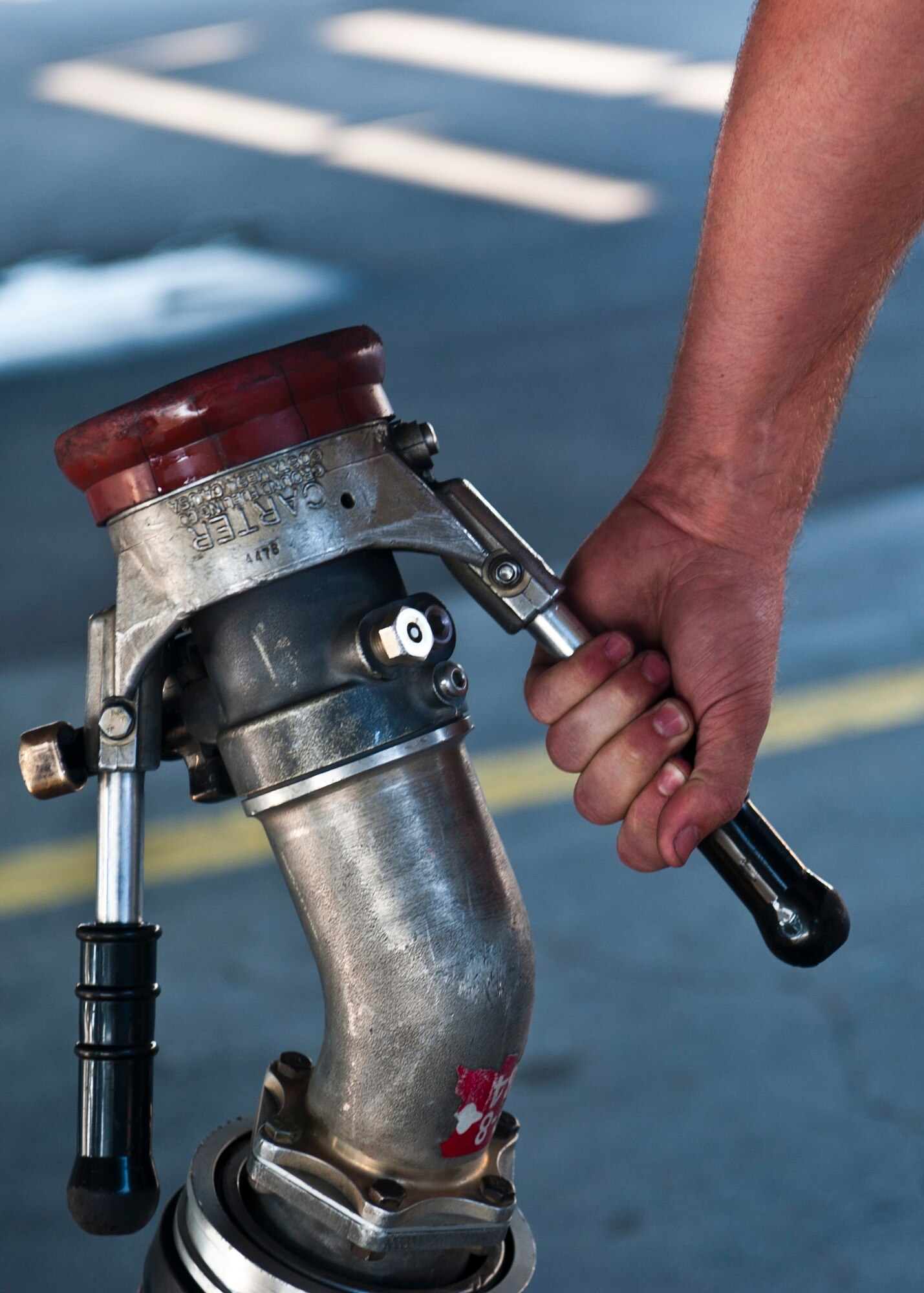 Senior Airman Matthew Kennedy holds a gas nozzle connected to a R-11 fuel truck at the Transit Center at Manas, Kyrgyzstan, July 18, 2012. The 376th Expeditionary Logistics Readiness Squadron Fuels Management Flight distributes up to 300,000 gallons of fuel to aircraft daily. Kennedy is a 376th Expeditionary Aircraft Maintenance Squadron crew chief deployed from McConnell Air Force Base, Kan. and is a native of Pocahontas, Va. (U.S. Air Force photo/Senior Airman Brett Clashman)