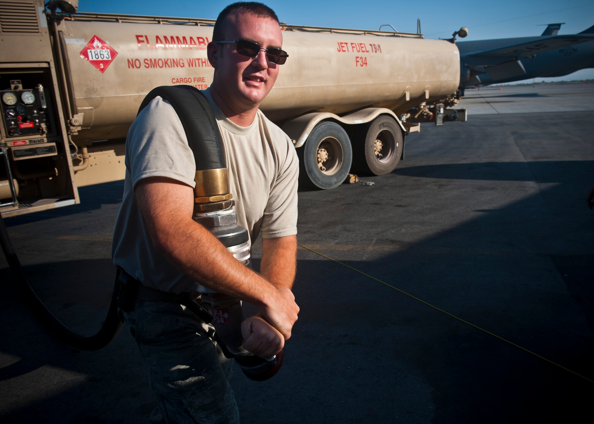 Senior Airman Zach Conoway carries a fuel hose to refuel a KC-135 Stratotanker at the Transit Center at Manas, Kyrgyzstan, July 18, 2012. The 376th Expeditionary Logistics Readiness Squadron Fuels Management Flight accomplishes more than 40 distribution runs daily. Conoway is a 376 ELRS fuels distribution journeyman deployed from Joint Base McGuire-Dix-Lakehurst, N.J. and is a native of Loganton, Pa. (U.S. Air Force photo/Senior Airman Brett Clashman)