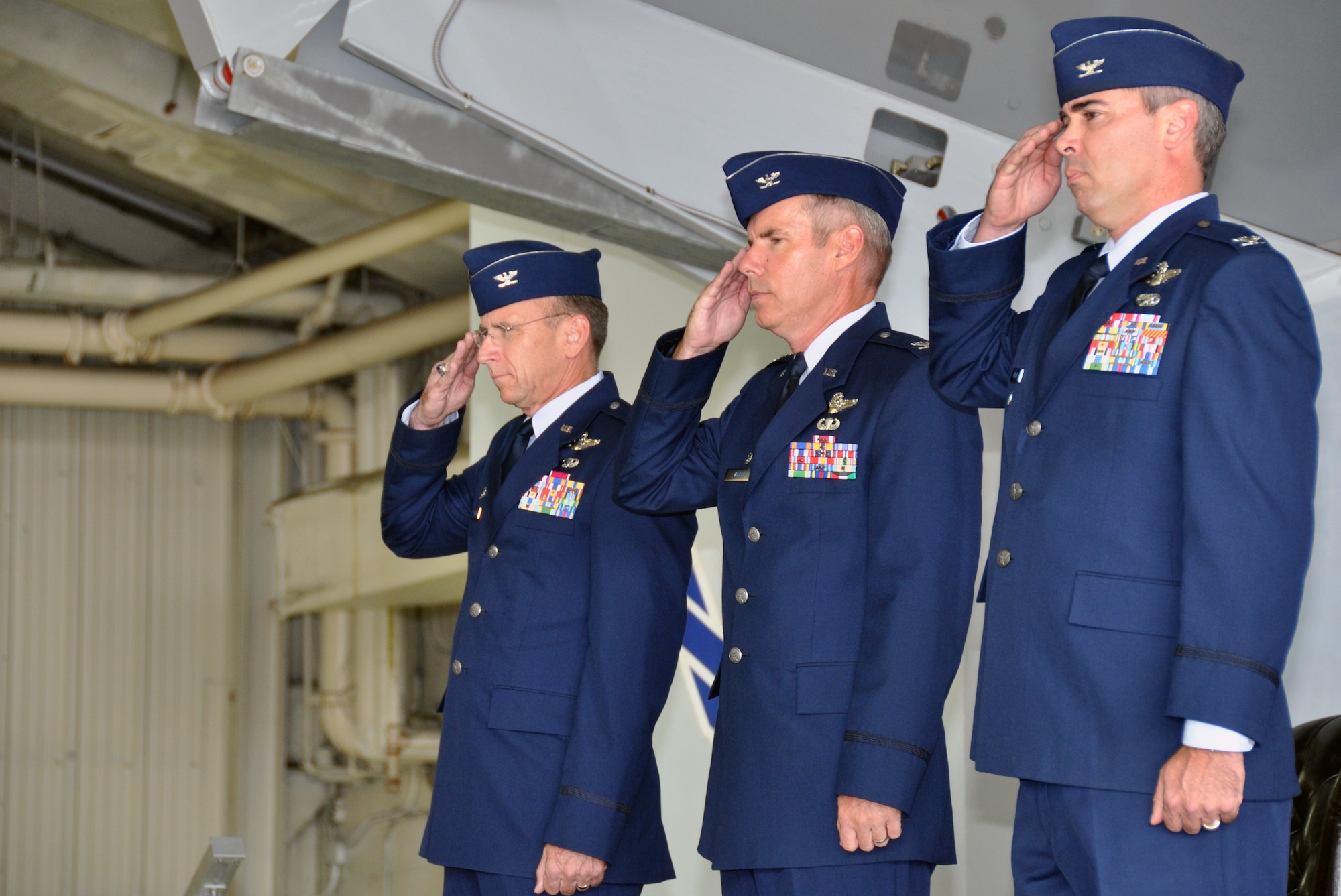 Col. Donald R. Lindberg, Commander, 482nd Fighter Wing (left), Col. Keith Acree, outgoing commander of the 414 Fighter Group (center), and Col. Kevin Fessler, incoming commander of the 414 Fighter Group (right), render a salute as the national anthem is played at 414th Fighter Group Change of Command Ceremony July, 12. The 414th Fighter group is part of the 482nd Fighter Wing at Homestead Air Reserve Base, Fla. and is located at Seymour Johnson Air Force Base as part of the Air Forces Total Force Integration Program. (U.S. Air Force photo/Senior Airman Jacob Jimenez, 482nd Fighter Wing Public Affairs)