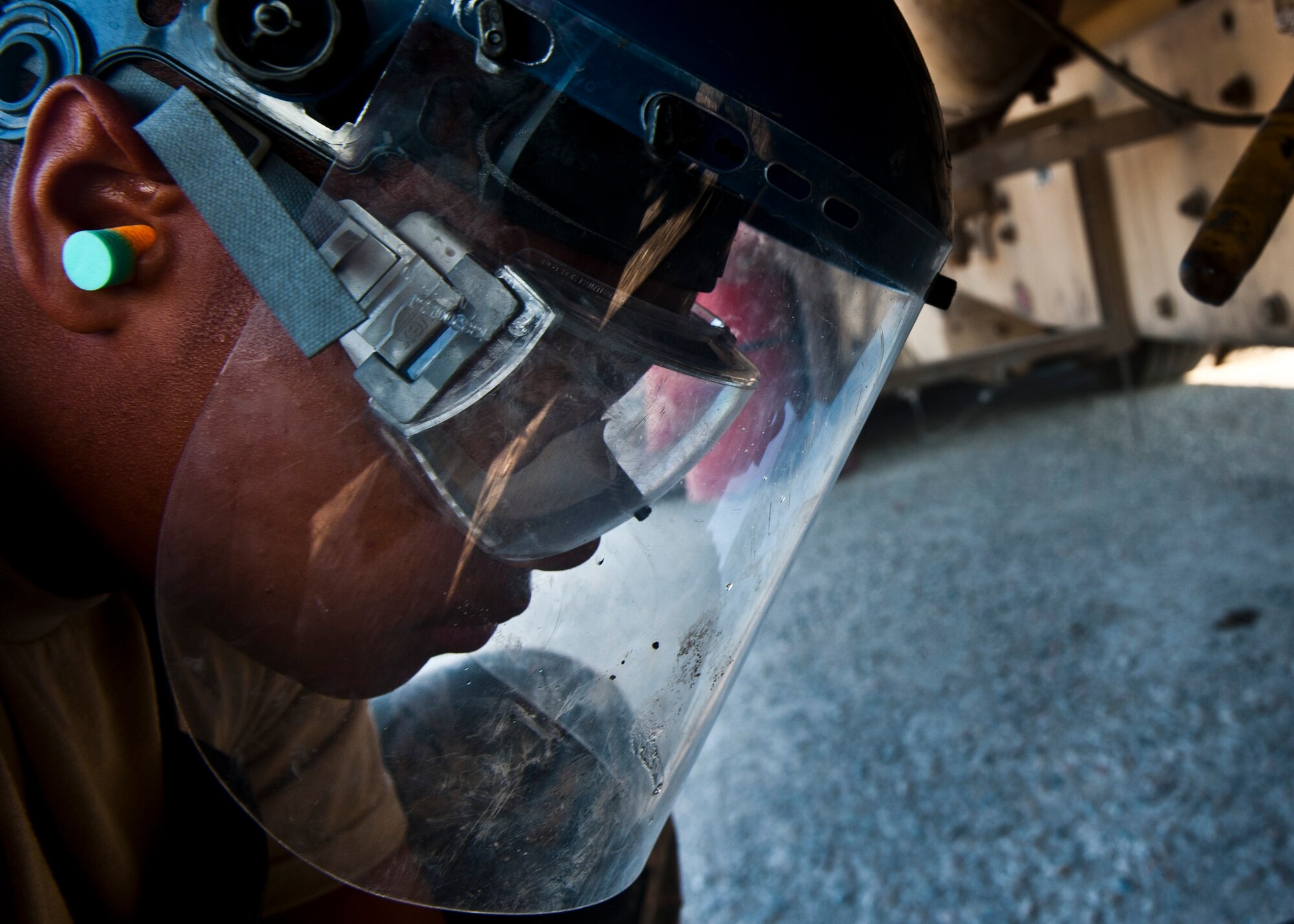 Airman 1st Class James Hancock looks down at a bucket of fuel underneath a R-11 fuel truck at the Transit Center at Manas, Kyrgyzstan, July 18, 2012. The 376th Expeditionary Logistics Readiness Squadron Fuels Management Flight personnel inspect fuel samples for dirt or foreign objects from every truck before distribution to aircraft. Hancock is a 376 ELRS fuels distribution journeyman deployed out of Little Rock Air Force Base, Ark. and is a native of Hampton, Va. (U.S. Air Force photo/Senior Airman Brett Clashman)
