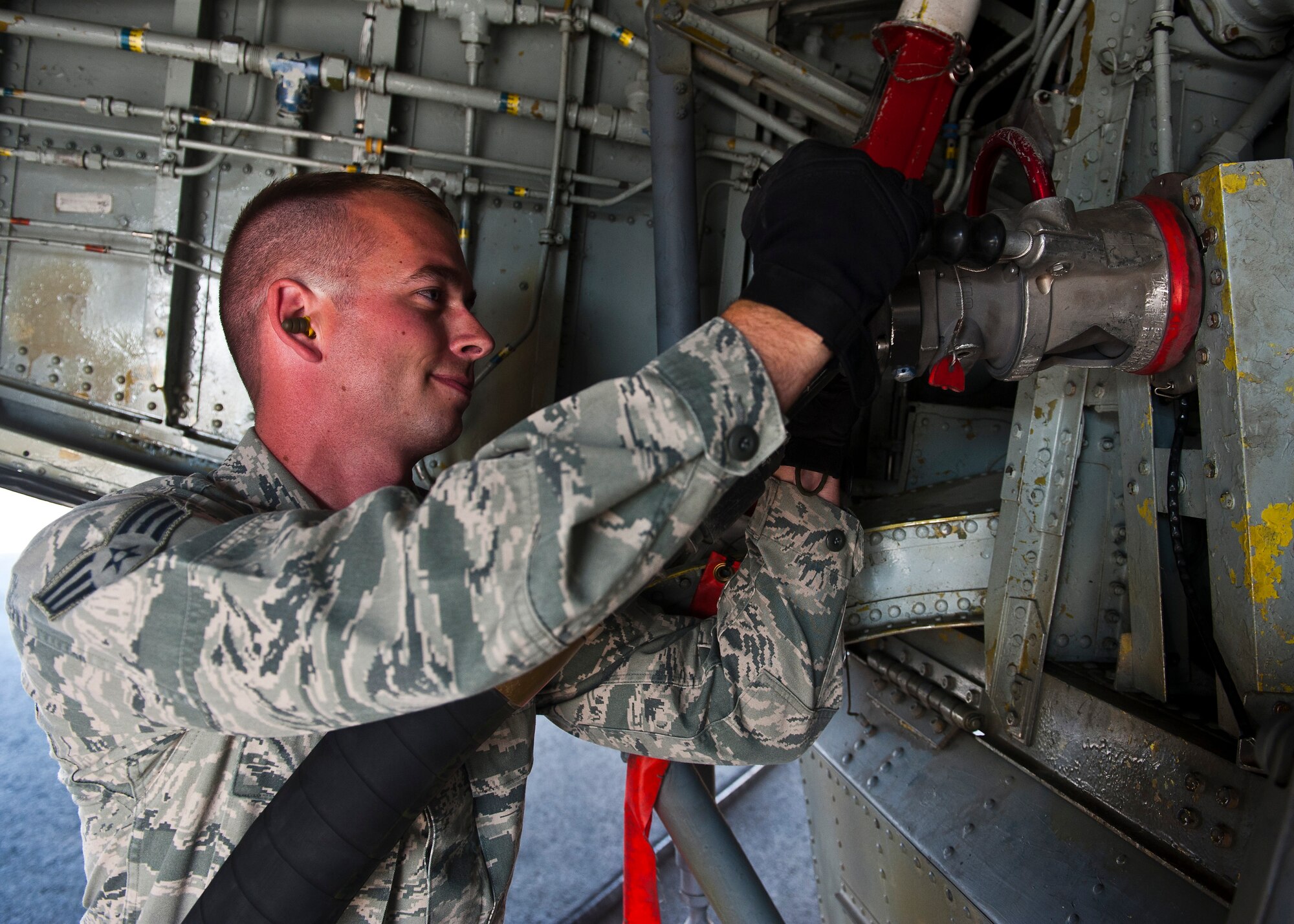 Senior Airman James Crandall connects a fuel hose to a KC-135 Stratotanker at the Transit Center at Manas, Kyrgyzstan, July 18, 2012. The 376th Expeditionary Logistics Readiness Squadron Fuels Management Flight distributes up to 300,000 gallons of fuel to aircraft daily. Crandall is a 376 ELRS fuels distribution journeyman deployed from Grand Forks Air Force Base, N.D. and is a native of Las Vegas. (U.S. Air Force photo/Senior Airman Brett Clashman)