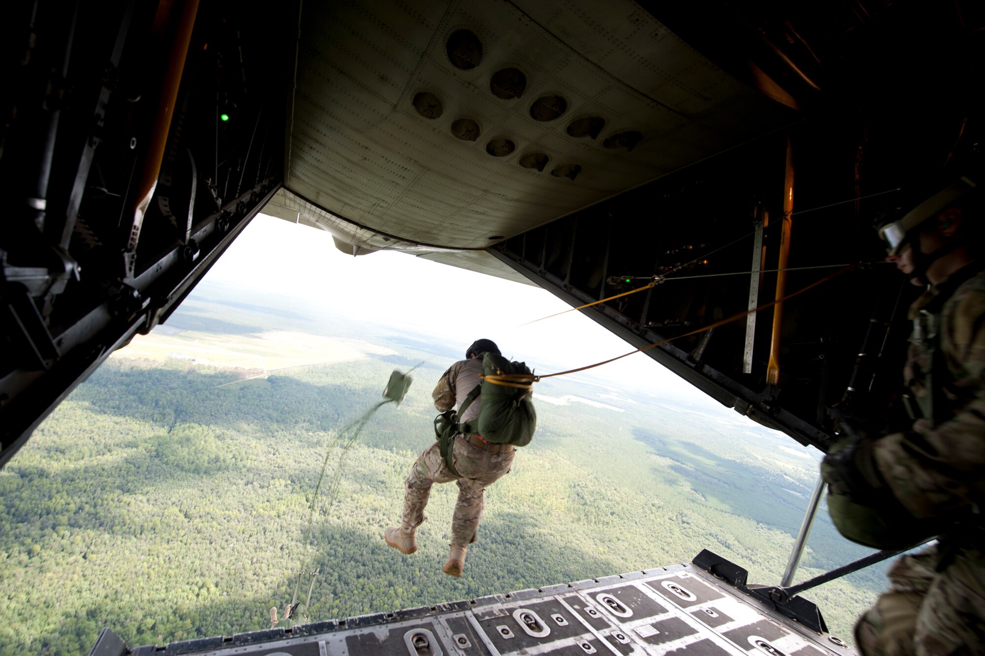 Airmen from the 38th Rescue Squadron jump out of an HC-130P Combat King July 16, 2012, over the skies of Moody Air Force Base, Ga. The 38th RQS trains, equips and employs combat-ready pararescueman, combat rescue officers and supporting Airmen in support of U.S. rescue operations. (U.S. Air Force photo by Staff Sgt. Jamal D. Sutter/Released)