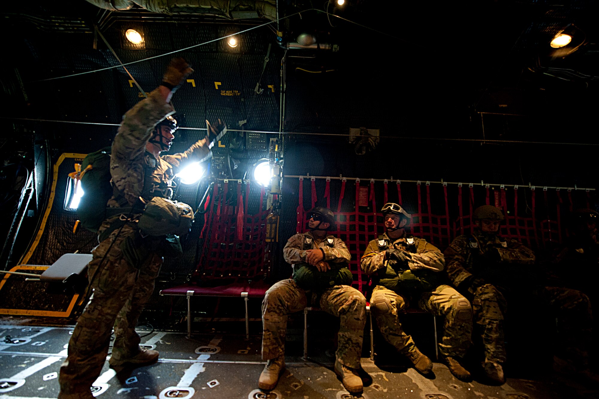 U.S. Air Force Staff Sgt. Freddie Kight, 38th Rescue Squadron pararescueman, gives instructions to his unit members while flying in an HC-130P Combat King July 16, 2012, over the skies of Moody Air Force Base, Ga. Kight ensured the Airmen knew the status of their mission and gave last-second instructions before conducting a static line jump. (U.S. Air Force photo by Staff Sgt. Jamal D. Sutter/Released)  