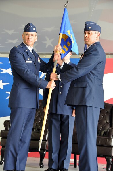 Col. Donald R. Lindberg, Commander, 482nd Fighter Wing, presents the 414th Fighter Group guidon to Col. Kevin Fessler, the new commander of the 414th Fighter Group at the Change of Command Ceremony, July 12.  The 414th FG is stationed at Seymour Johnson Air Force Base and includes both the 307th Fighter Squadron and the 414th Maintenance Squadron they fly and maintain F-15E Strike Eagles of the 4th Fighter Wing and the F16CJ Fighting Falcons of the 20th Fighter Wing at Shaw Air Force Base, S.C. (U.S. Air Force photo/Senior Airman Jacob Jimenez, 482nd Fighter Wing Public Affairs)