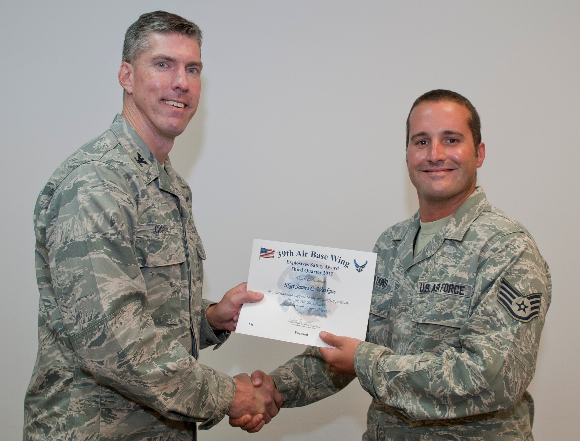 Col. Chris Craige, 39th Air Base Wing commander, left, presents Staff Sgt. James Watkins, 39th Maintenance Squadron, with the third quarter Explosives Safety Award July 19, 2012, at Incirlik Air Base, Turkey. The award is given to individuals or units that excelled in their safety program. (U.S. Air Force photo by Senior Airman Anthony Sanchelli/Released)