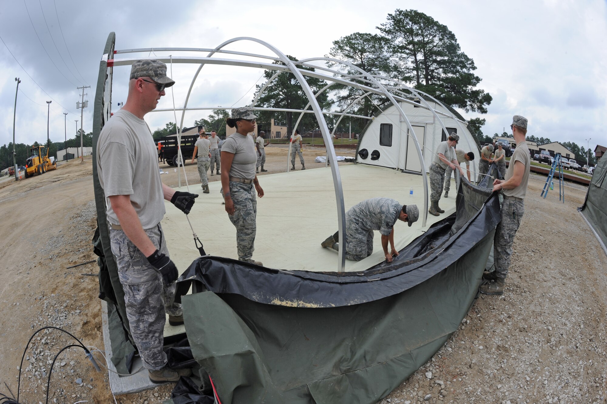 U.S. Air Force Airmen assigned to the 4th Fighter Wing prepare to erect a tent’s canopy in preparation for the upcoming operational readiness exercise on Seymour Johnson Air Force Base, N.C., July 11, 2012. The exercise will test Airmen’s effectiveness in working as a unified team in a contingency environment. (U.S. Air Force photo/Airman 1st Class Aubrey Robinson/Released)