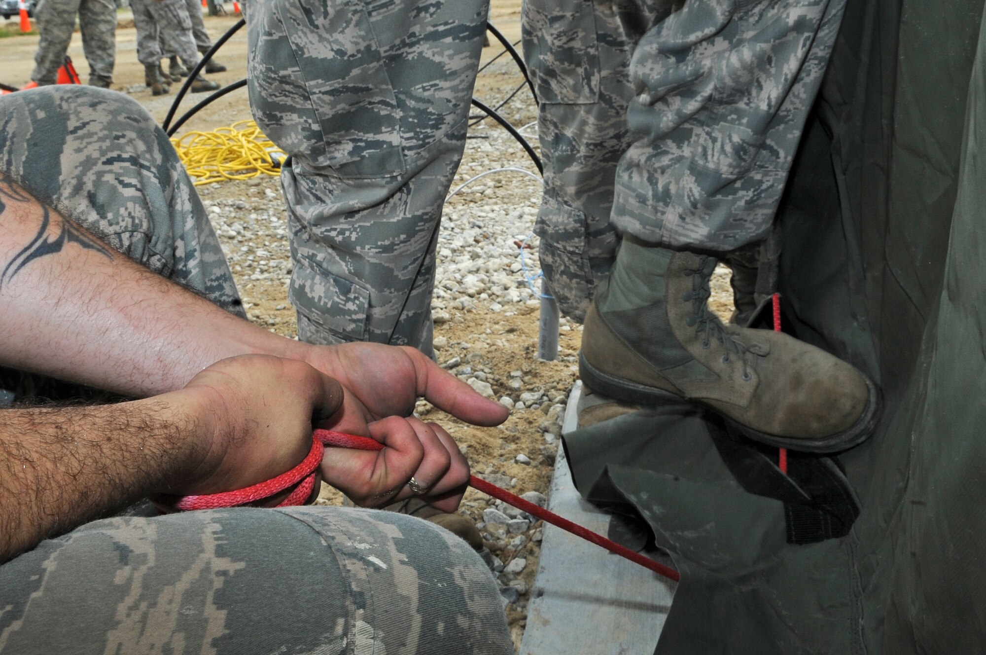 U.S. Air Force Airmen assigned to the 4th Fighter Wing tighten a rope on a tent on Seymour Johnson Air Force Base, N.C., July 11, 2012. The Airmen spent the day re-building tents in preparation for an upcoming operational readiness exercise. (U.S. Air Force photo/Airman 1st Class Aubrey Robinson/Released)