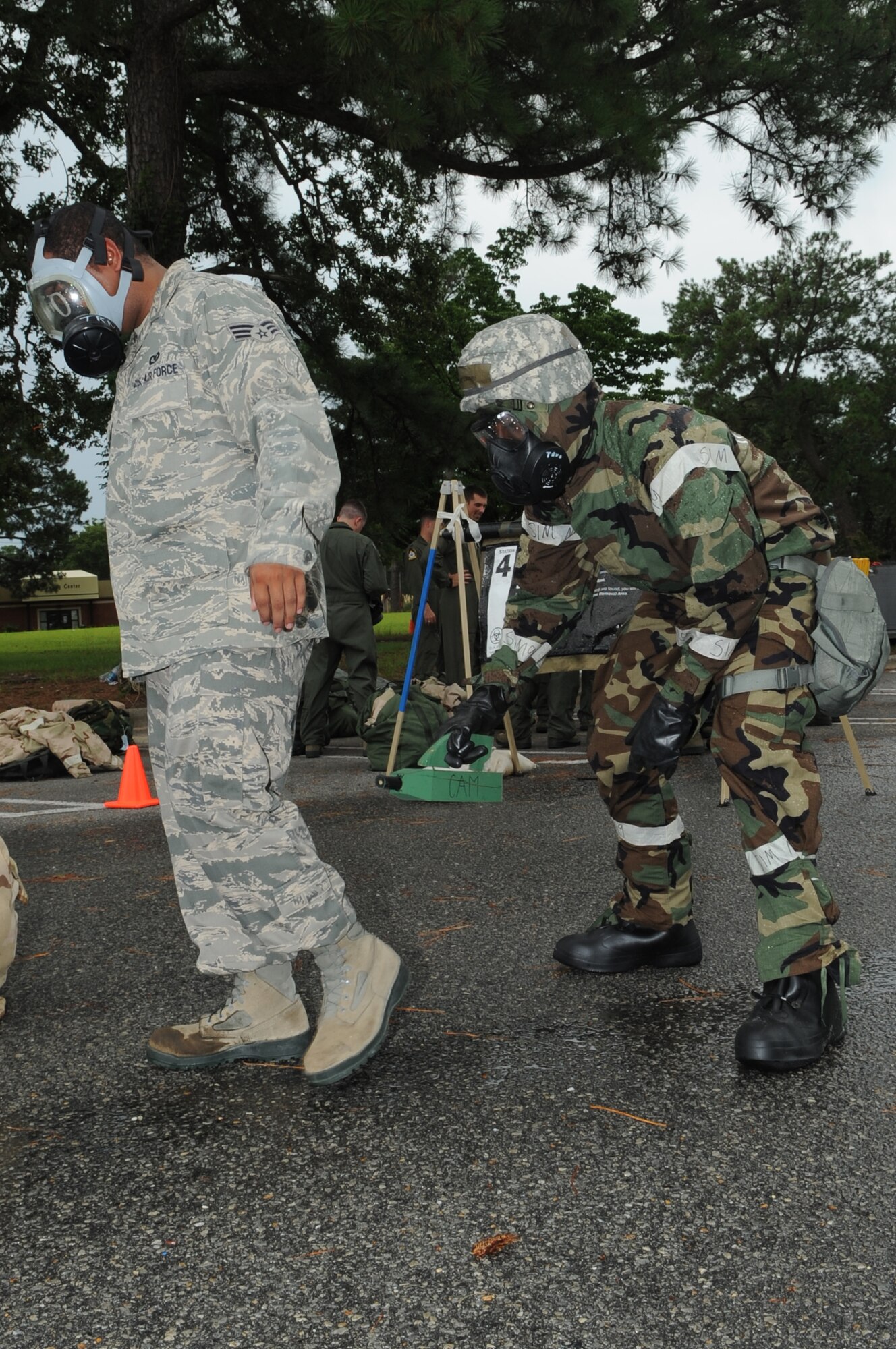 U.S. Air Force Airman 1st Class Shadwick Williams, 4th Civil Engineer Squadron engineer assistant, simulates scanning Senior Airman Trevis Huggins, 335th Fighter Squadron aviation resource management systems technician, in a contamination control area on Seymour Johnson Air Force Base, N.C., July 13, 2012. Military members are scanned to detect chemical agents in a real-world CCA in order to avoid potential contamination. (U.S. Air Force photo/Airman 1st Class Aubrey Robinson/Released)