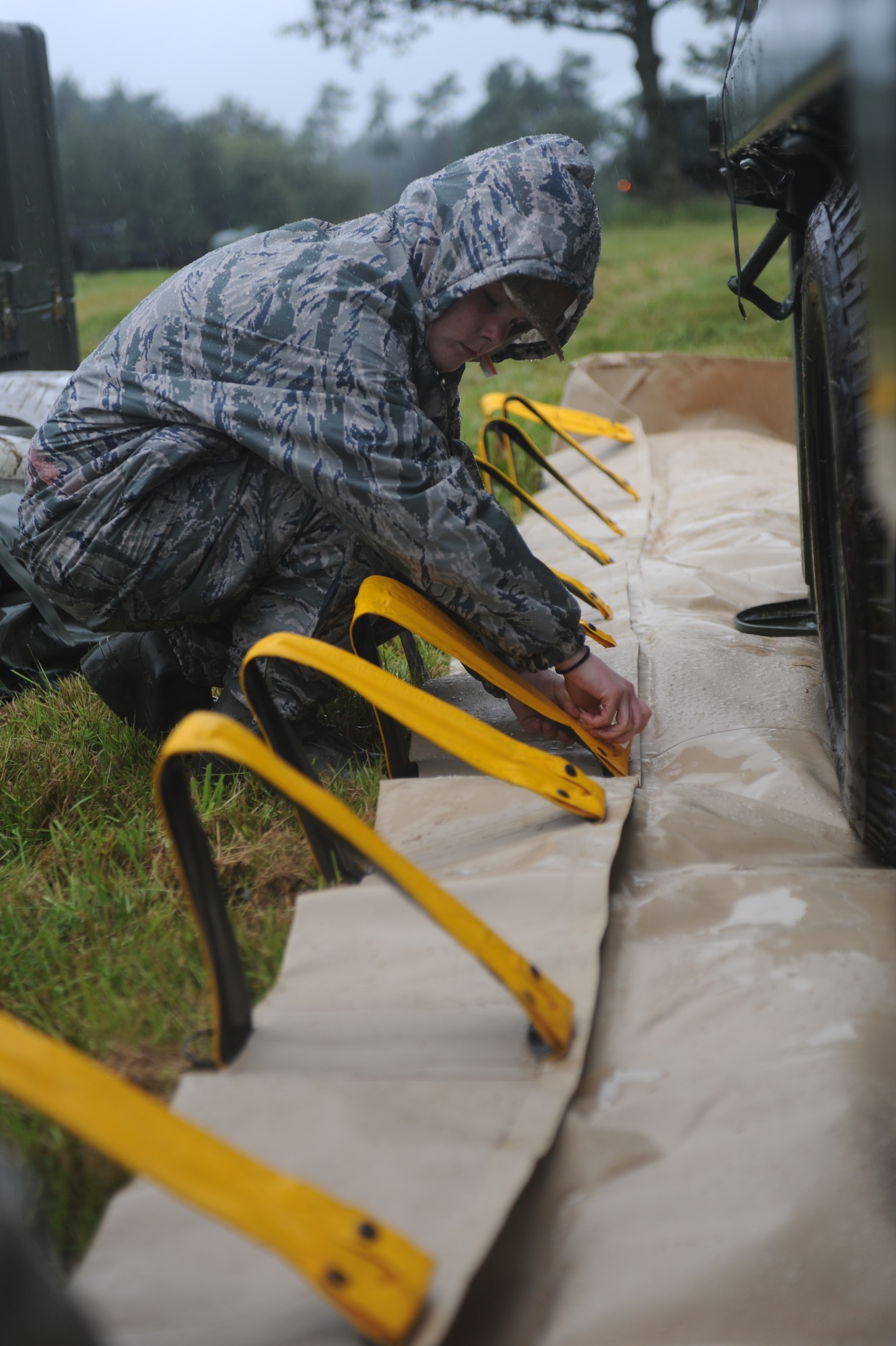 GEROLSTEIN, Germany – Senior Airman Caley Jett, 606th Air Control Squadron supply technician, sets up a protective mat that keeps diesel produced from generators from leaking into the soil during Eifel Strike 2012 July 12 here. Eifel Strike is an annual field training exercise in which Airmen build a controlled radar site, and a control and reporting center to work and live from for a week. Exercises like this help Spangdahlem Airmen prepare for contingency operations around the world. It also designed to give them the practice, skills and experience they need to deploy efficiently and effectively within a moment’s notice. (U.S. Air Force photo by Senior Airman Natasha Stannard/Released)