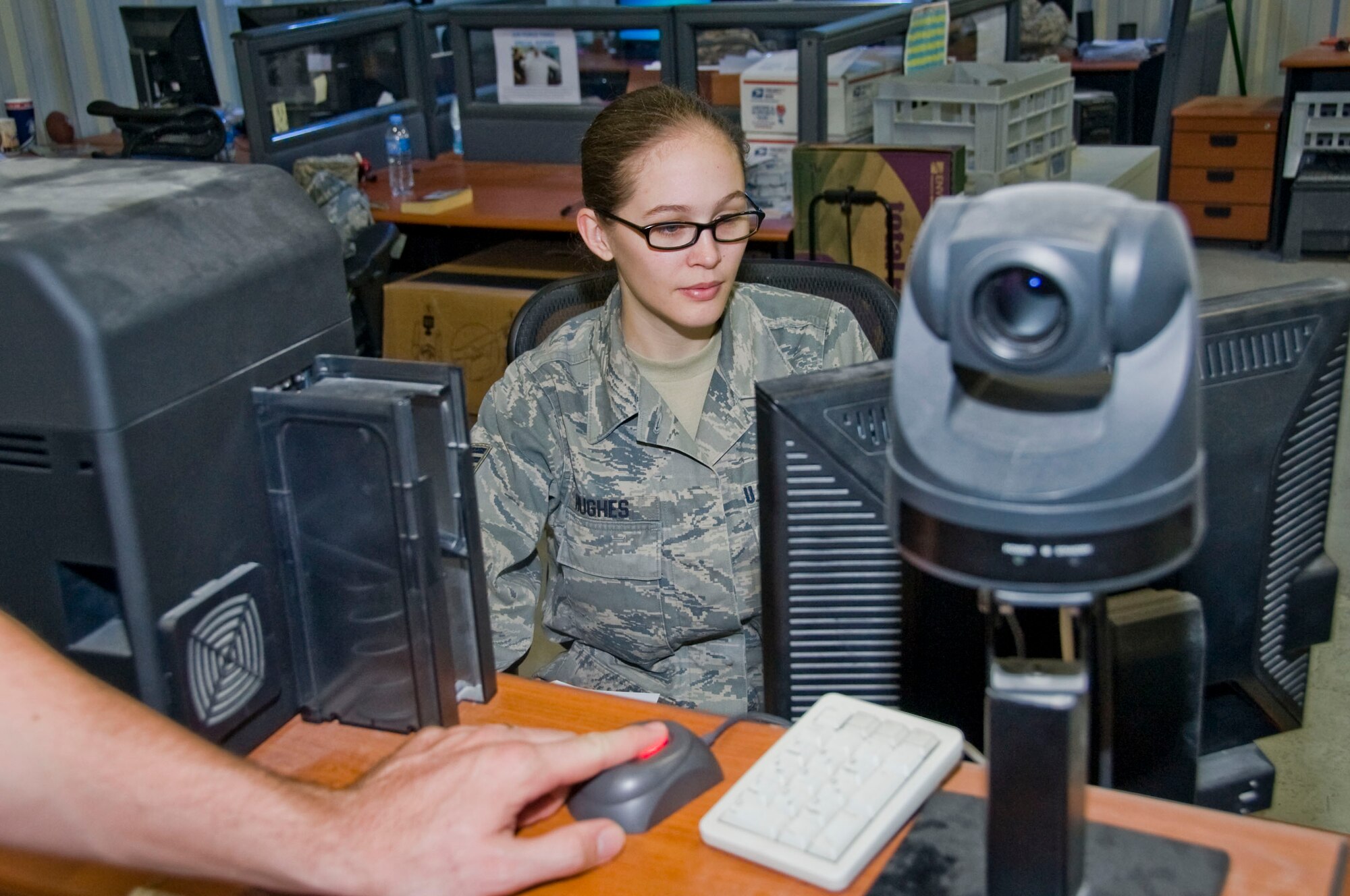 Senior Airman Amanda Hughes, 379th Expeditionary Force Support Squadron Personnel Support for Contingency Operations customer service clerk, creates a new common access card for a service member here July 10, 2012. The 379th EFSS PERSCO team is the largest in the Air Force, consisting of 20 members. (U.S. Air Force photo/Senior Airman Bryan Swink)