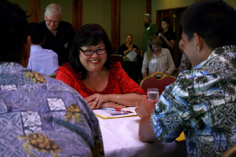 Honolulu District Deputy for Small Business Programs Cathy Yoza meets with small business representatives to discuss opportunities with the Corps during the 10th Annual DoD Hawai'i Small Business Forum held at the Honolulu Country Club on Thursday, July 12, 2012.