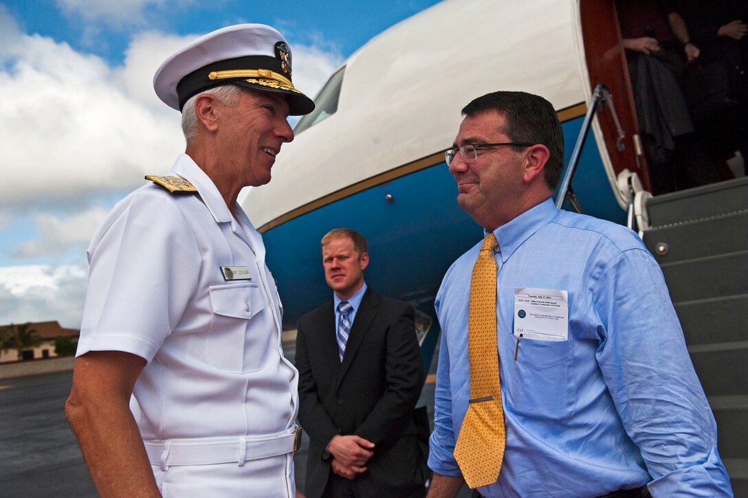 Navy Adm. Samuel J. Locklear III, commander of U.S. Pacific Command, left, greets Deputy Defense Secretary Ashton B. Carter upon his arrival on Joint Base Pearl Harbor-Hickam, Hawaii, July 17, 2012. Carter visited the state to kick off a 10-day trip to the Asia-Pacific region with stops in Guam, Japan, Thailand, India and South Korea.