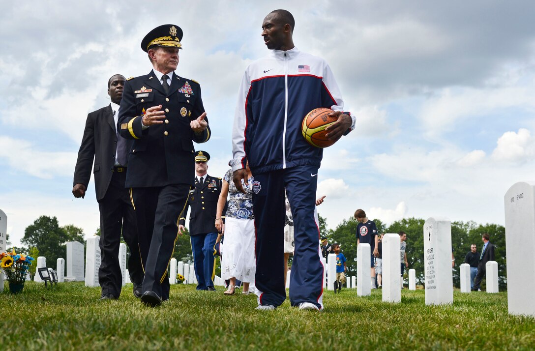 Army Gen. Martin E. Dempsey, chairman of the Joint Chiefs of Staff, walks with professional basketball player Kobe Bryant at Arlington National Cemetery, Arlington, Va., July 15, 2012. Bryant, a member of the Los Angeles Lakers, will play on the USA Olympic basketball team in London.