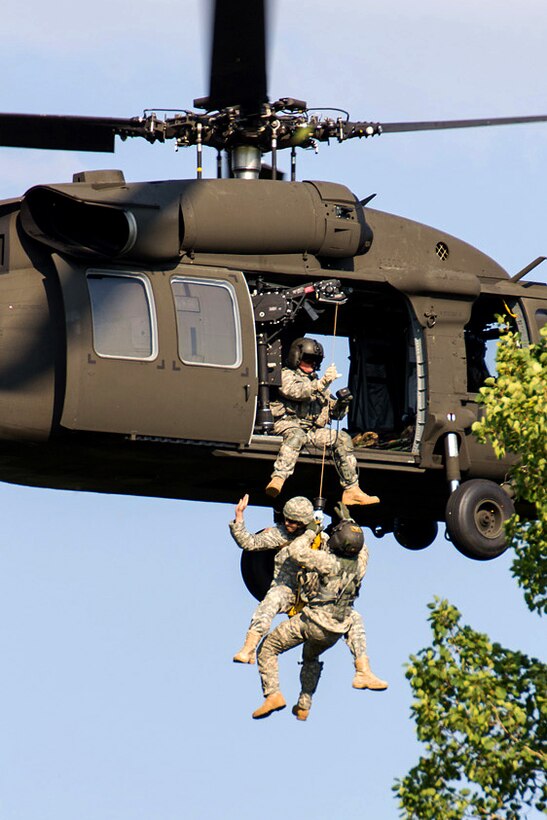 An Army crew chief lifts a soldier into a UH-60 Black Hawk helicopter during medical evacuation training in Marcy, N.Y., July 12, 2012. The crew chief is assigned to Company F, 1st Battalion,169th General Support Aviation Battalion, New York Army National Guard.