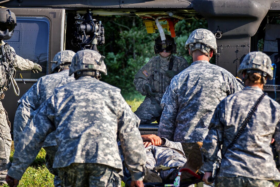 Soldiers carry a simulated casualty onto a UH-60 Black Hawk helicopter during medical evacuation training in Marcy, N.Y., July 12, 2012.