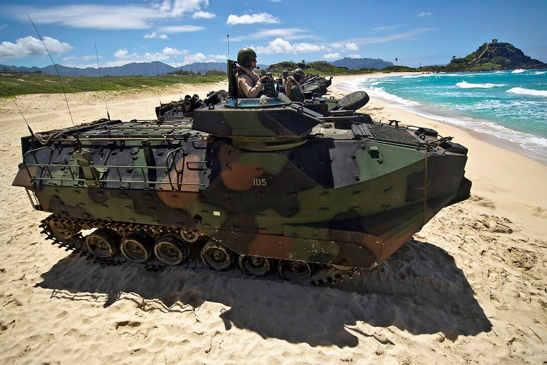 U.S. Marines wait in R7-A1 amphibious assault vehicles before meeting offshore with the USS Essex during Rim of the Pacific 2012 on Pyramid Rock Beach, Hawaii, July 12, 2012.