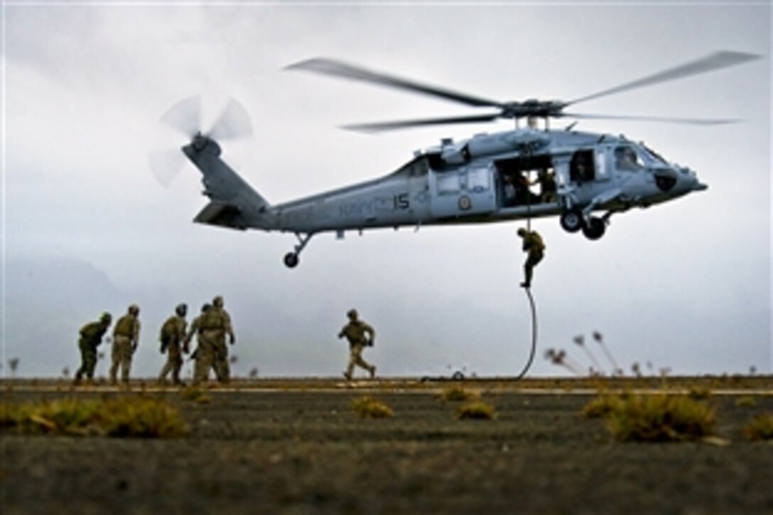 U.S., Australian and Canadian sailors fast rope out of a U.S. Navy MH-60S Nighthawk helicopter from Helicopter Sea Combat Squadron 4 during Rim of the Pacific 2012, an international maritime exercise, on Marine Corps Base Hawaii, Kaneohe Bay, July 16, 2012. Twenty-two nations, more than 40 ships and submarines, more than 200 aircraft and 25,000 people are participating in the exercise in and around Hawaii.