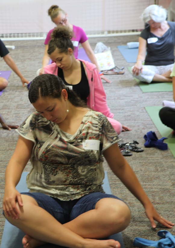 Participants at the “It’s All About You,” mid-deployment workshop at the Russell Marine and Family Center aboard the base take a moment to take care of their bodies by practicing yoga techniques, July 7. Classes were thought on reflexology, yoga, making healthy treats, and making homemade spa treatments.