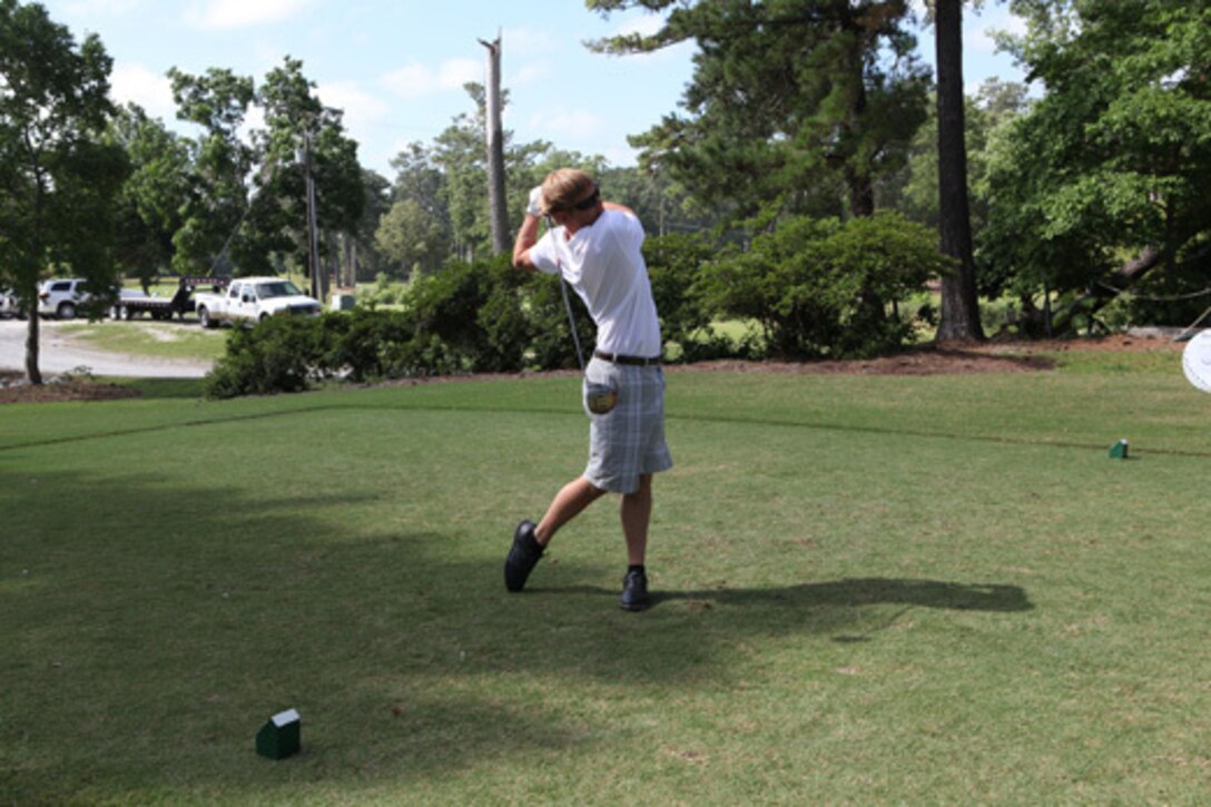 A golfer strikes the ball during the Military Heroes Golf Classic June 15 at the Jacksonville Country Club. The event drew more than one hundred participants, including three teams of wounded warriors.