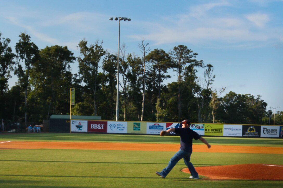 Lance Cpl. Cory D. Polom, a combat correspondent with Cherry Point public affairs, throws the ceremonial first pitch at a Morehead City Marlins baseball game at Big Rock Stadium, July 17. "Being in the military I do not get a lot of time or chances to play baseball," said Polom, a native of Chesaning, Michigan. "This has been a great honor."
