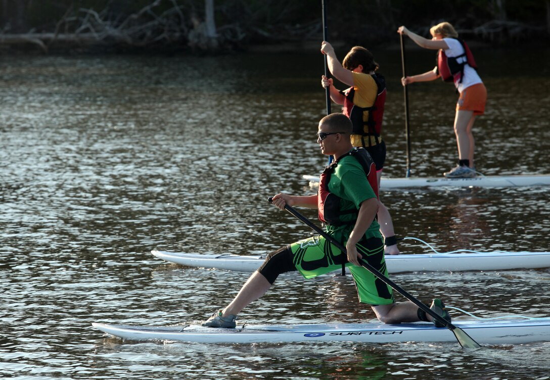 Competitors in the paddleboard relay-race take off in the hopes of winning first place for their company during the Commander’s Cup Challenge July 20 at the Gottschalk Marina aboard Marine Corps Base Camp Lejeune. The relay-race is the first challenge in the new 12-month cup cycle, with Company A winning the last cycle of events.