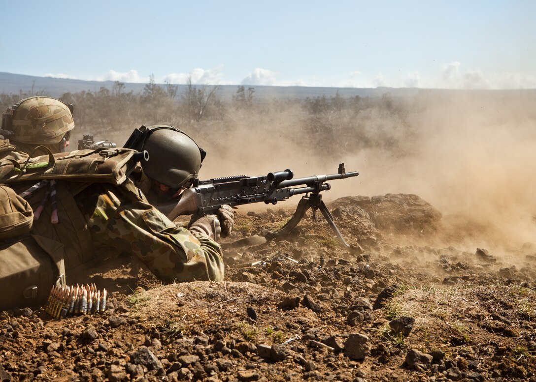 Australian machine gunners with 1st Battalion, Royal Australian Regiment from Townsville, Queensland, establish a support by fire position during a platoon-size live-fire training range as part of Rim of the Pacific, 2012, July 19. Approximately 2,200 personnel from 9 nations comprise SPMAGTF-3, Combined Force Land Component Command. The CFLCC is conducting amphibious and land-based operations in order to enhance multinational and joint interoperability.